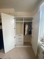 Lidded wardrobe fitted into an alcove to match an exsisting wardrobes already fitted at the opposite side (doors open), fitted in Darlington